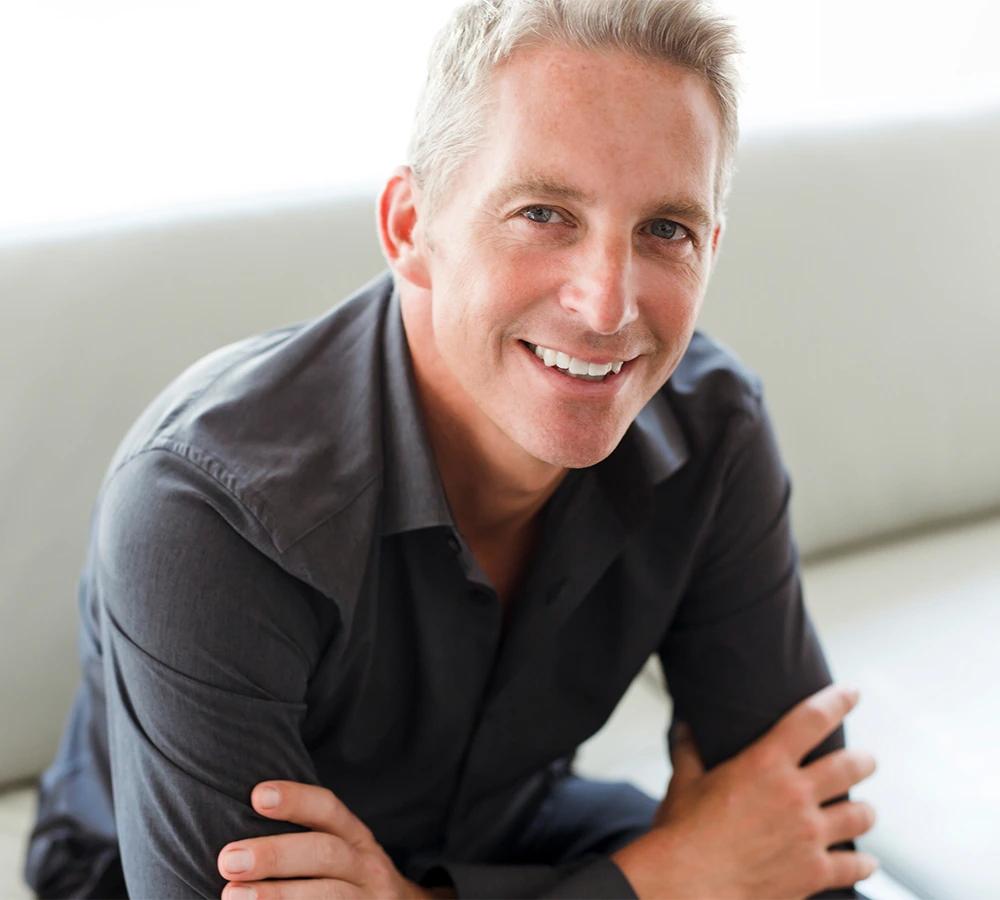 handsome man in his 50's sitting on sofa
