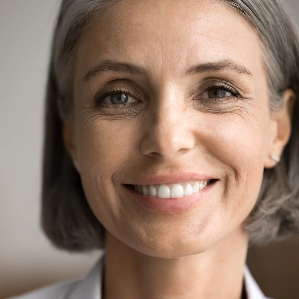 middle aged woman smiling into the camera