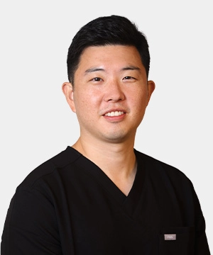 Samuel Kim, MD headshot in scrubs