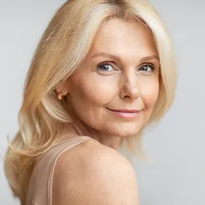 older woman smiling beautifully towards the camera