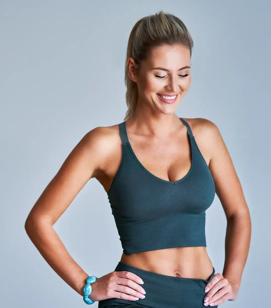 woman feeling confident in sporty outfit with beautiful physique